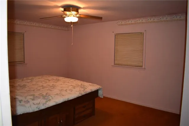 a view of a small space with wooden floor and a window