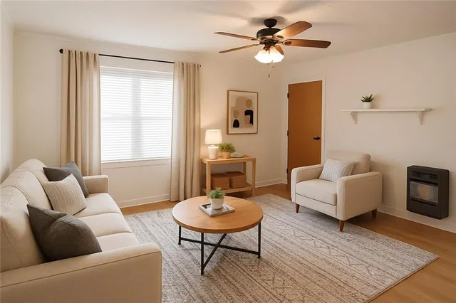 a living room with furniture a table and a large window