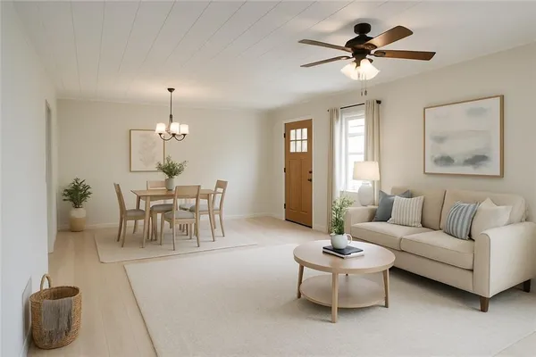 a living room with furniture and a chandelier