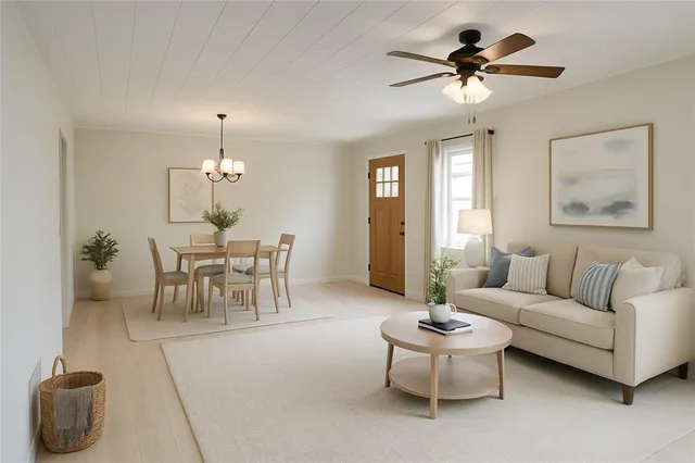 a living room with furniture and a chandelier