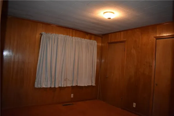 a spacious bedroom with a bed and a potted plant