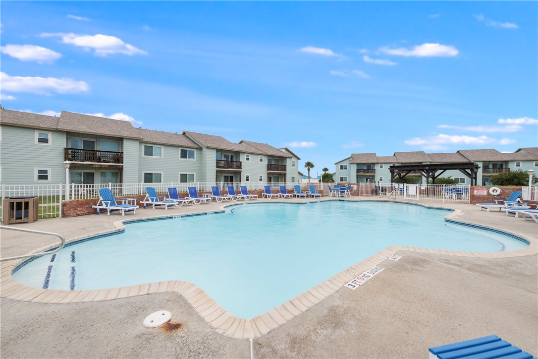 230 Cut-Off Road, Unit 101 Port Aransas, TX 78373 - Photo 26 of 30 a view of a swimming pool with outdoor seating