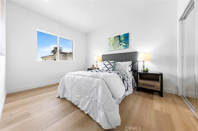 a view of a tennis court with a house in the background