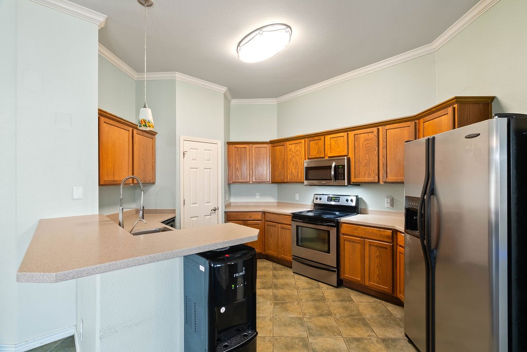 7510 Geiger Drive Corpus Christi, TX 78414 - Photo 6 of 15 a kitchen with stainless steel appliances a sink stove refrigerator and a window