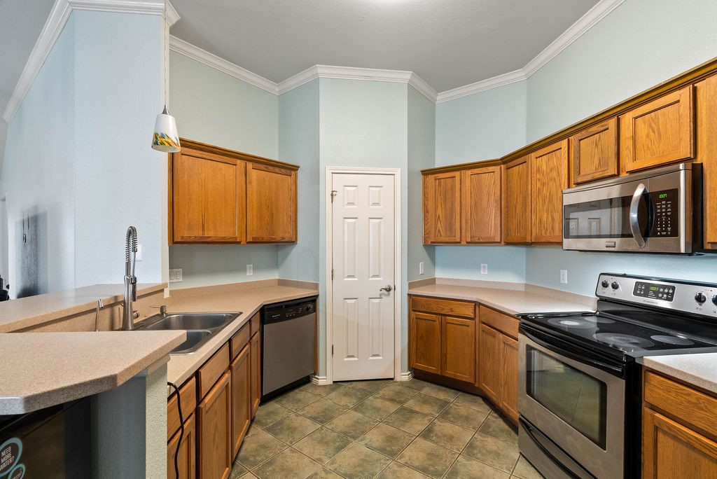 7510 Geiger Drive Corpus Christi, TX 78414 - Photo 7 of 15 a kitchen with stainless steel appliances granite countertop a sink stove and refrigerator