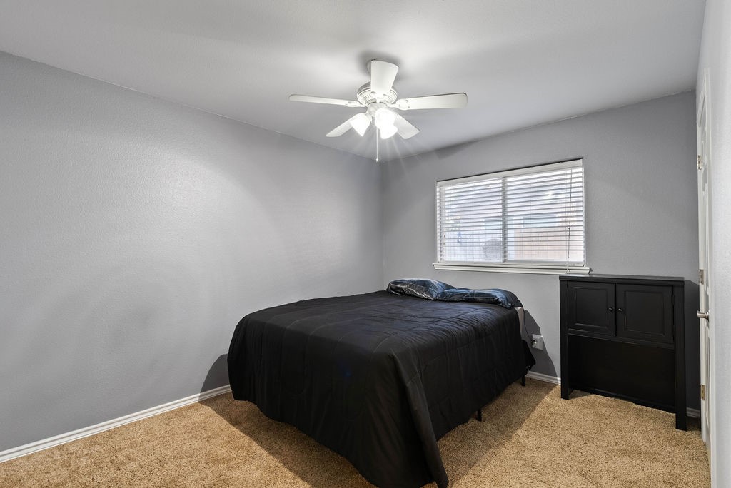 7510 Geiger Drive Corpus Christi, TX 78414 - Photo 8 of 15 a bedroom with a bed and a chandelier
