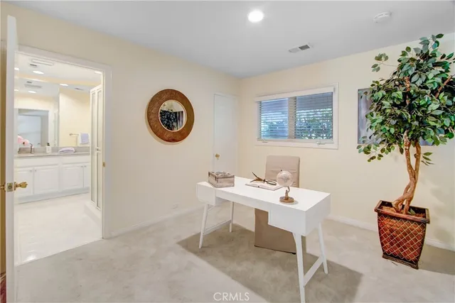 a spacious bedroom with a bed and a wooden floor