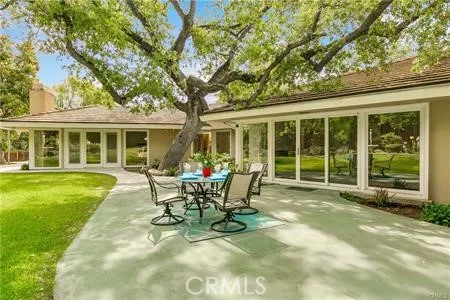 a view of a house with backyard sitting area and garden
