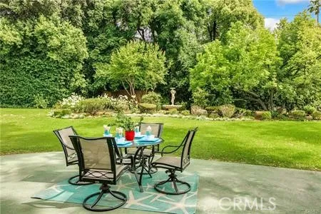 a view of a backyard with table and chairs