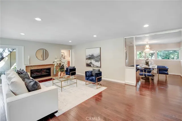 a living room with furniture and a floor to ceiling window