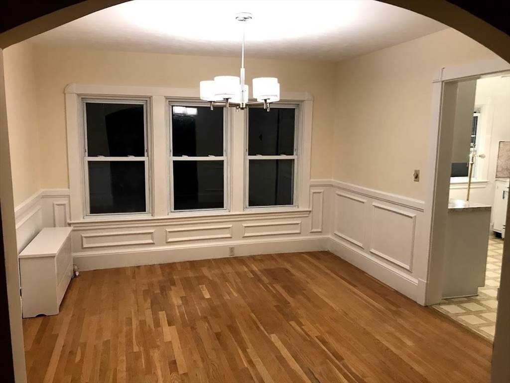 28 Beaconsfield Road, Unit 1 Brookline, MA 02445 - Photo 6 of 21 a view of a bedroom with wooden floor and windows