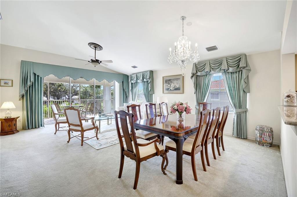 6200 Reserve Circle, Unit 404 Naples, FL 34119 - Photo 15 of 47 a dining room with furniture a chandelier and window