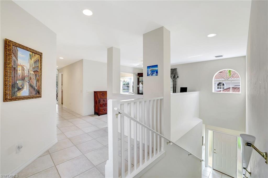 6200 Reserve Circle, Unit 404 Naples, FL 34119 - Photo 18 of 47 Entry hall and landing where 2200 sq. feet of single level living space abounds.
