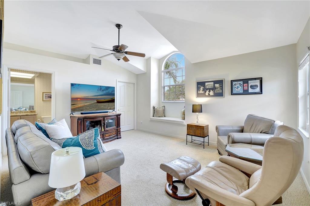 6200 Reserve Circle, Unit 404 Naples, FL 34119 - Photo 19 of 47 a living room with furniture a flat screen tv and a window