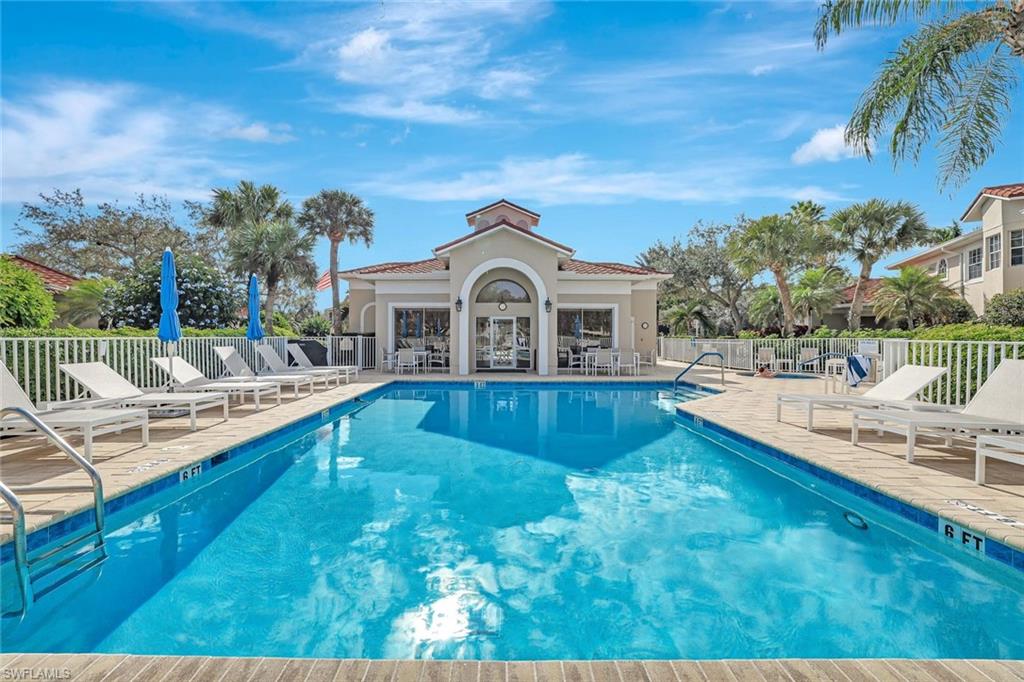 6200 Reserve Circle, Unit 404 Naples, FL 34119 - Photo 39 of 47 a view of a house with a swimming pool