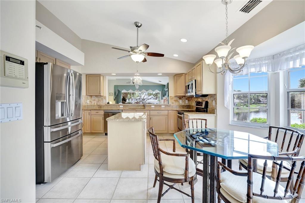 6200 Reserve Circle, Unit 404 Naples, FL 34119 - Photo 10 of 47 Eat-in kitchen, lofted ceiling, stainless steel appliances, ceiling fan, lake views beaming with natural light.