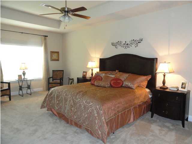 Lot 401 Pin Oak Loop Santa Rosa Beach, FL 32459 - Photo 11 of 13 a bedroom with a bed and a chandelier