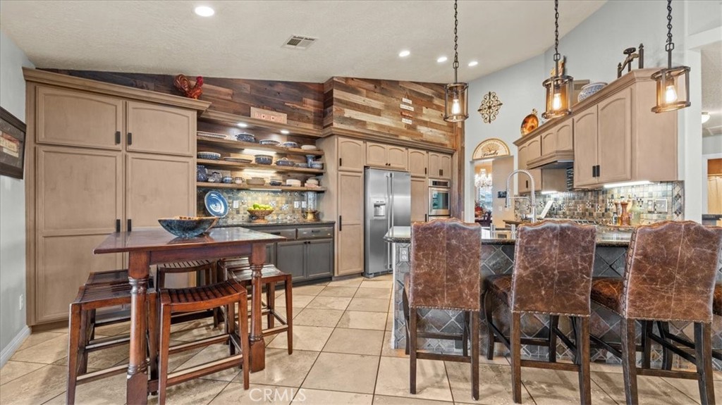 12920 Choco Road Apple Valley, CA 92308 - Photo 11 of 39 Kitchen with bar seating and adjacent dining area, offering everyday functionality and easy flow