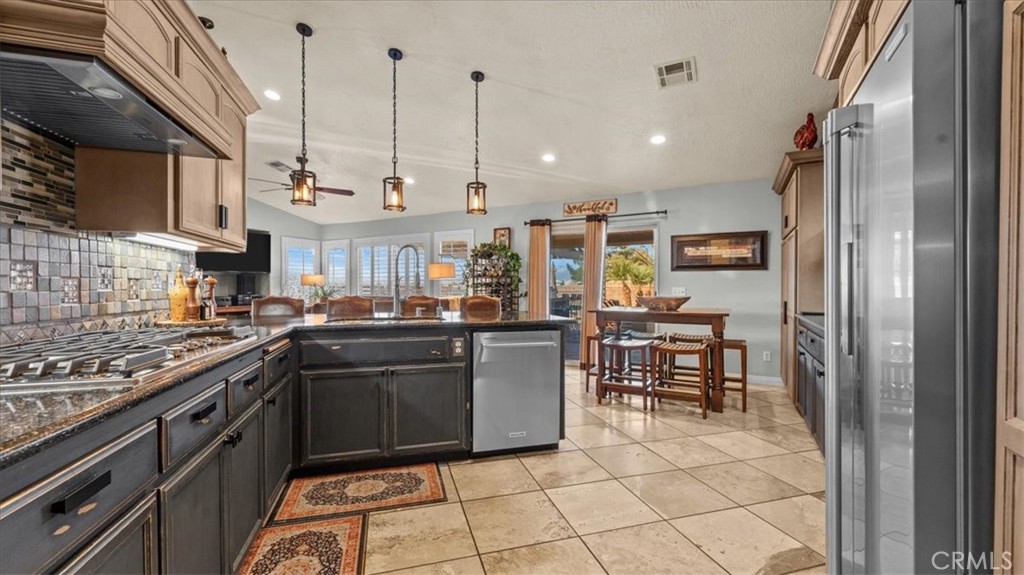 12920 Choco Road Apple Valley, CA 92308 - Photo 13 of 39 Opposite angle of kitchen showcasing High-end KitchenAid and Electrolux Icon appliances (included)