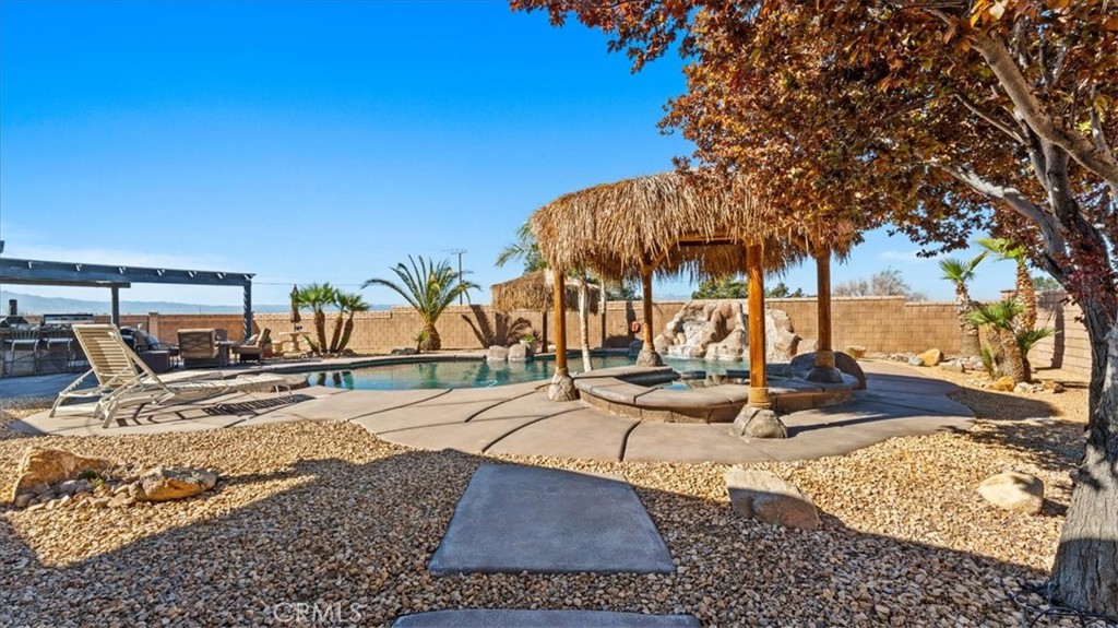 12920 Choco Road Apple Valley, CA 92308 - Photo 30 of 39 Backyard wide shot: Multiple outdoor living spaces designed for hosting and relaxation