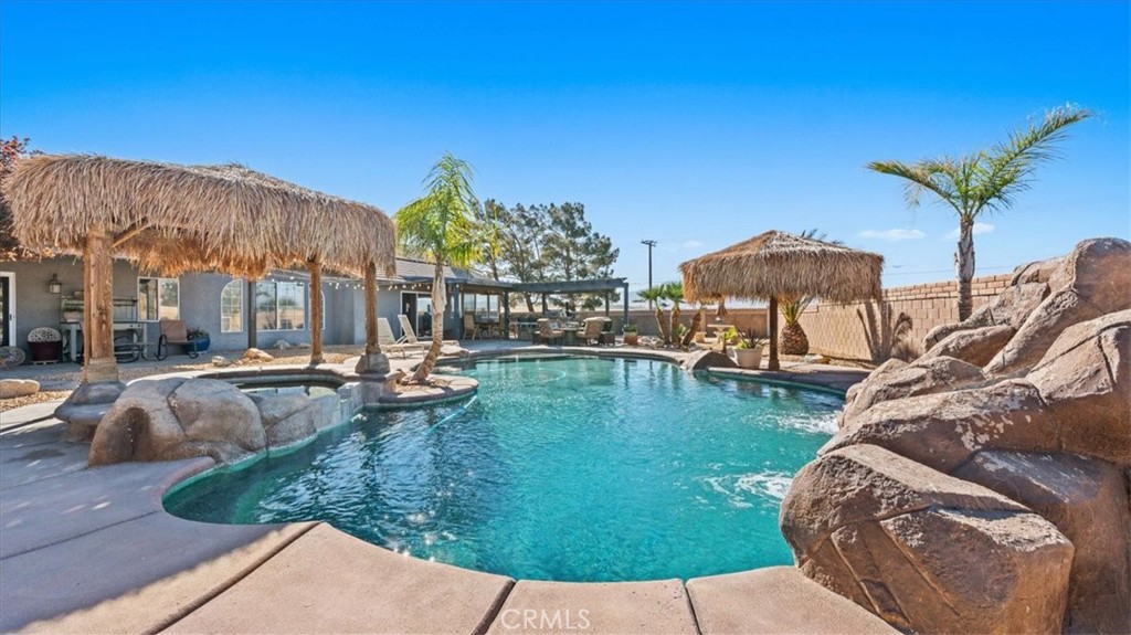 12920 Choco Road Apple Valley, CA 92308 - Photo 32 of 39 Saltwater pool and spa with rock waterfall and slide feature