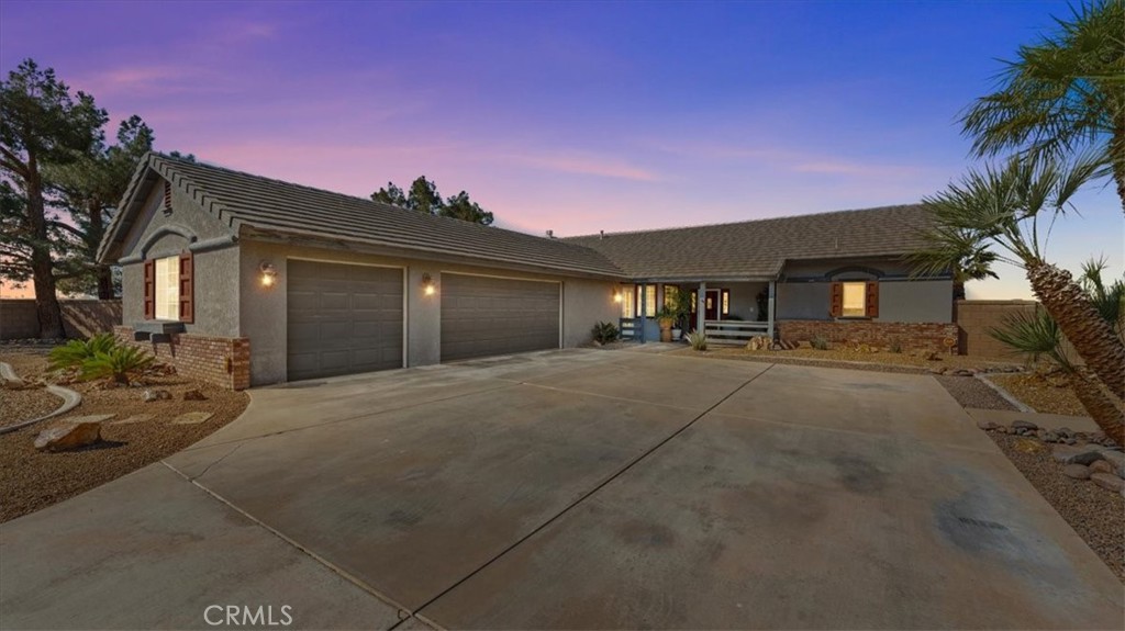 12920 Choco Road Apple Valley, CA 92308 - Photo 39 of 39 Front twilight
Evening curb appeal highlighting the home’s corner lot presence
