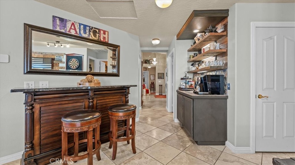 12920 Choco Road Apple Valley, CA 92308 - Photo 9 of 39 Dedicated bar and serving area with open shelving and custom cabinetry