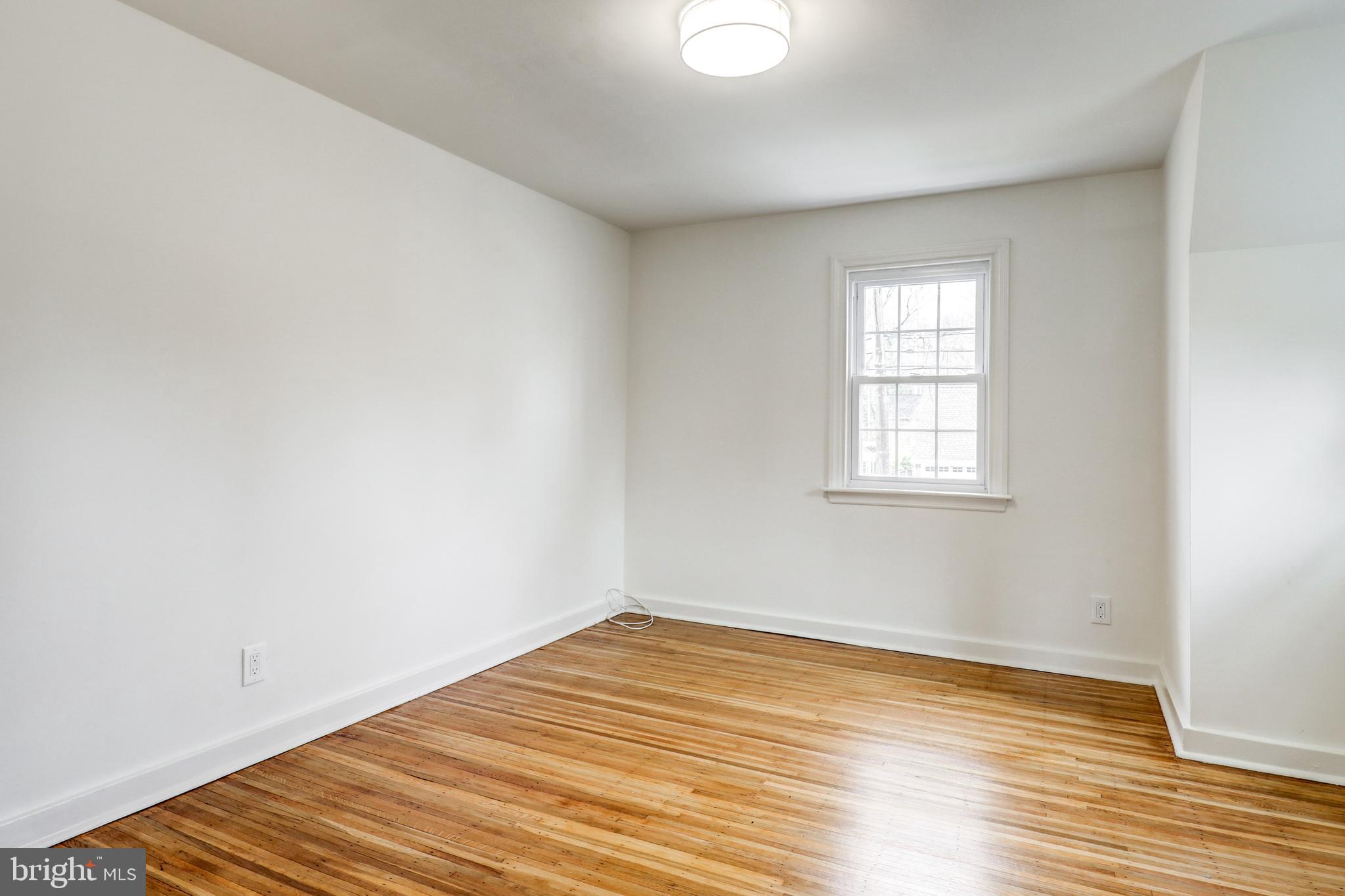 2316 Franklin Avenue Secane, PA 19018 - Photo 20 of 30 an empty room with wooden floor and windows