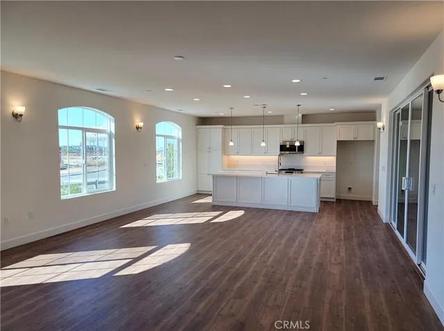 a view of kitchen with wooden floor and electronic appliances