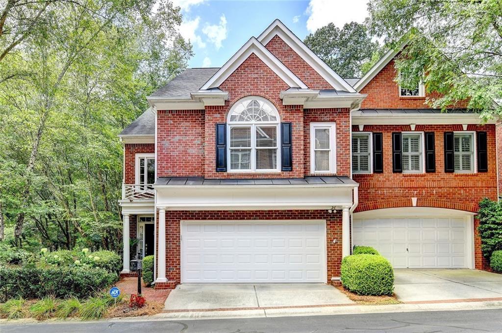 1 Carrington Way Atlanta, GA 30328 - Photo 1 of 1 a front view of a house with a yard and garage