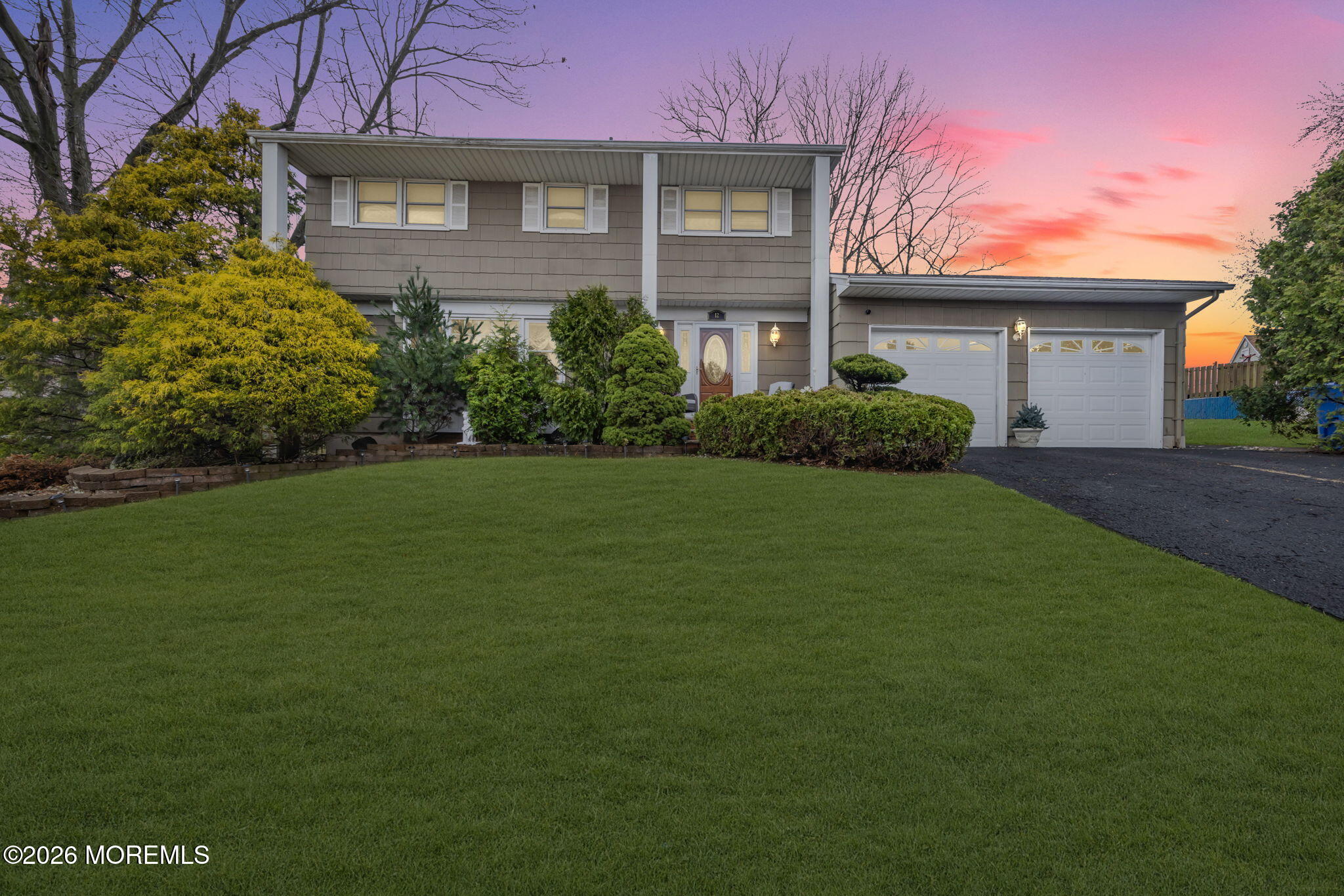 a front view of a house with a garden