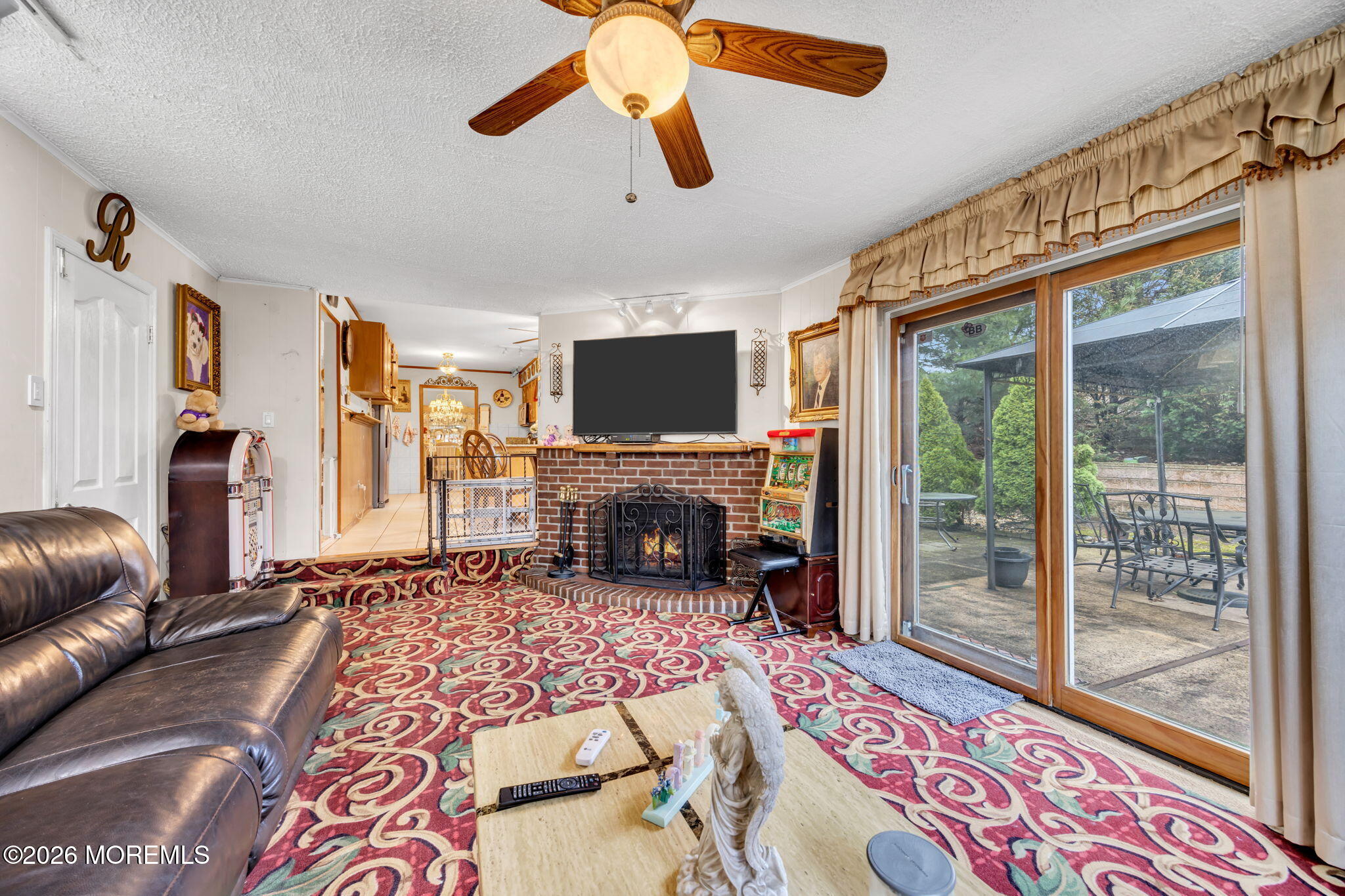 12 Avon Way Parlin, NJ 08859 - Photo 14 of 29 a living room with furniture a fireplace and a flat screen tv