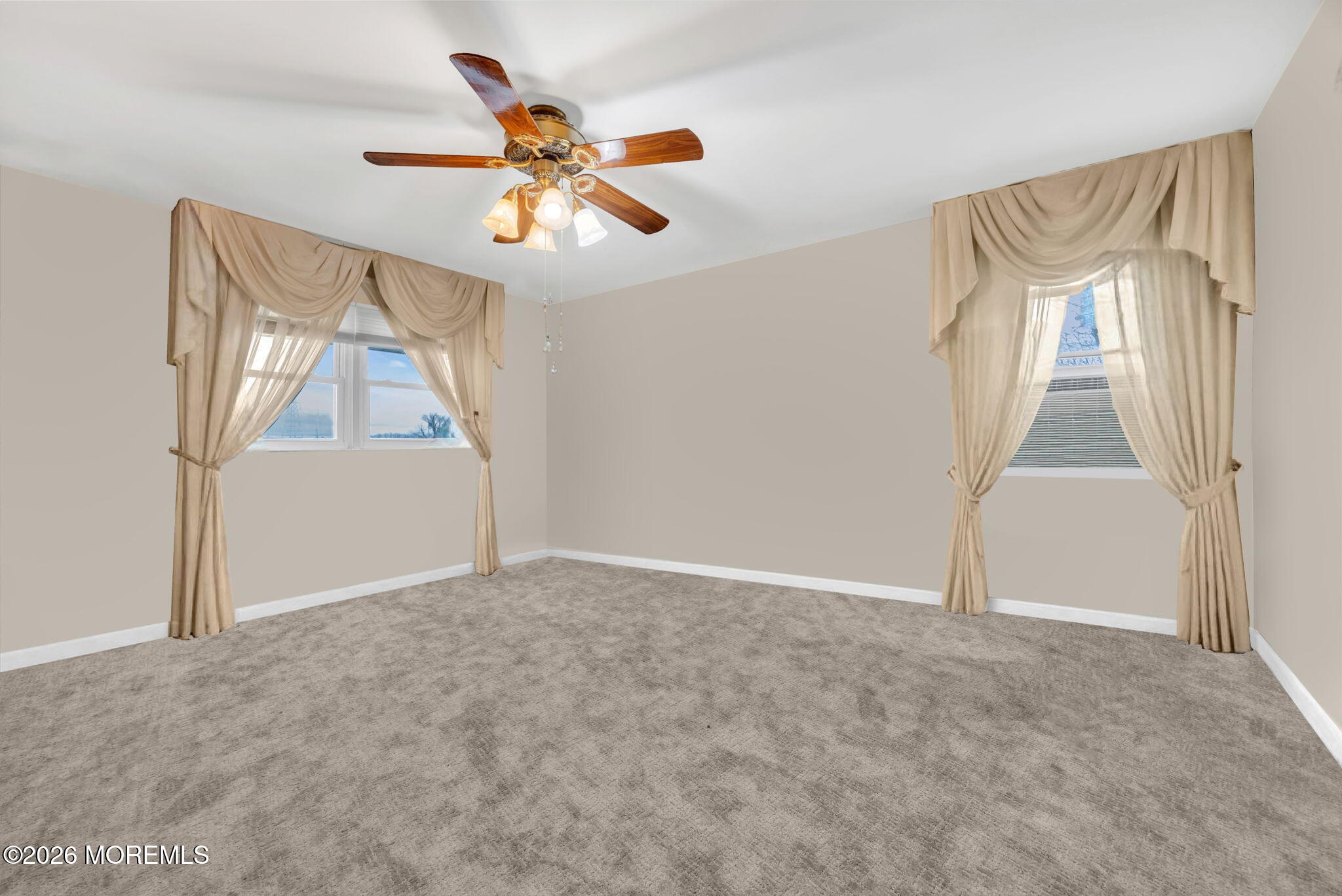 12 Avon Way Parlin, NJ 08859 - Photo 22 of 29 an empty room with windows and fan