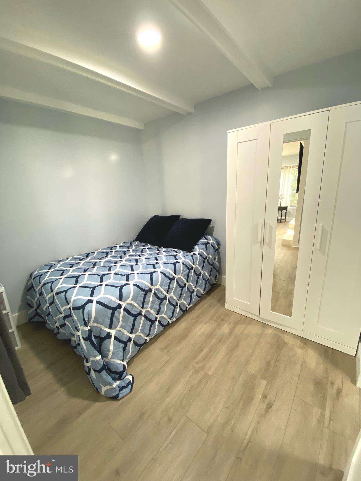 9712 Hellingly Place, Unit 209 Gaithersburg, MD 20886 - Photo 15 of 29 a bedroom with a bed and a cabinets