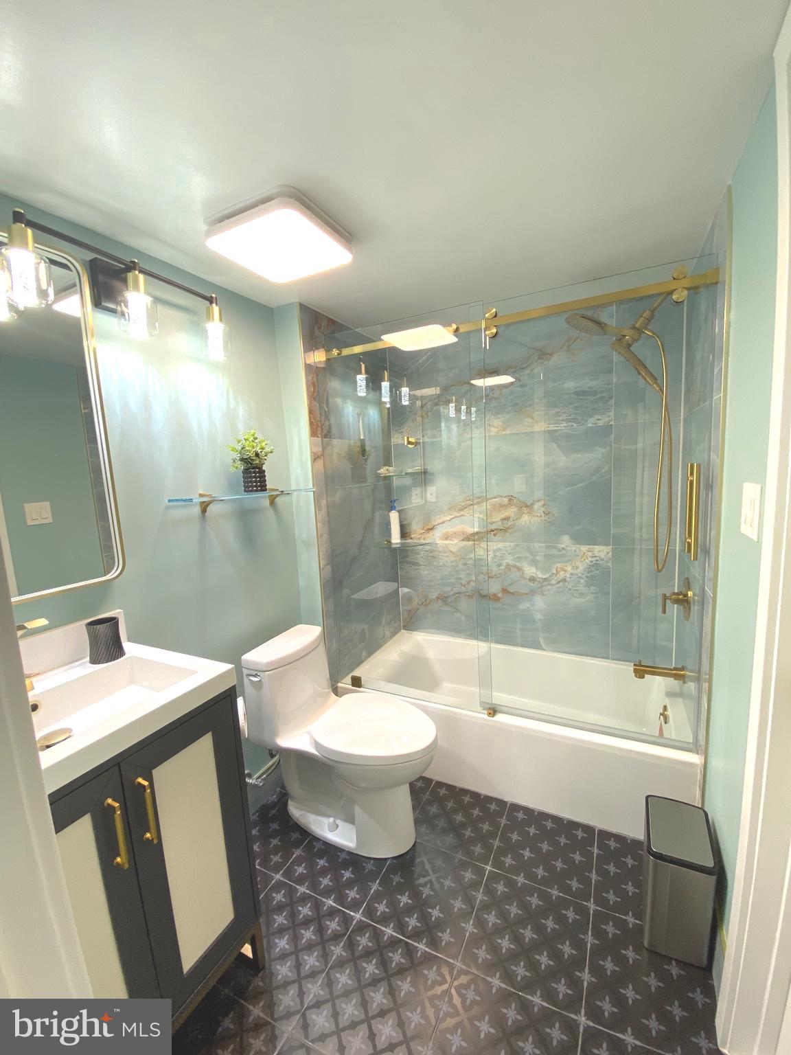 9712 Hellingly Place, Unit 209 Gaithersburg, MD 20886 - Photo 17 of 29 a bathroom with a bathtub shower sink vanity and toilet