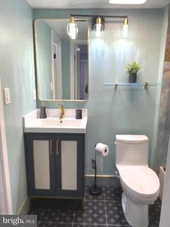 a bathroom with a sink a toilet and a mirror