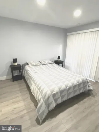 a bedroom with a bed and chair