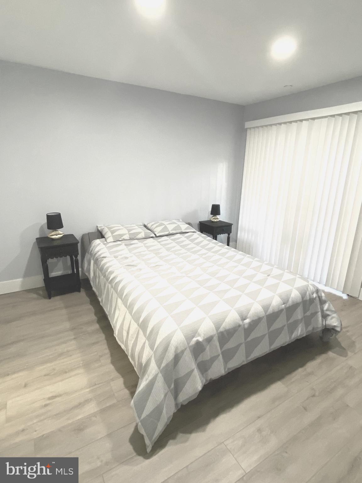 9712 Hellingly Place, Unit 209 Gaithersburg, MD 20886 - Photo 19 of 29 a bedroom with a bed and chair