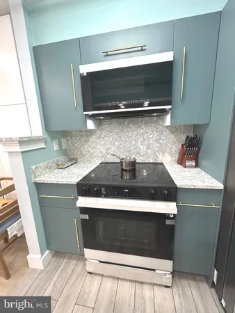 a kitchen with a stove and a sink