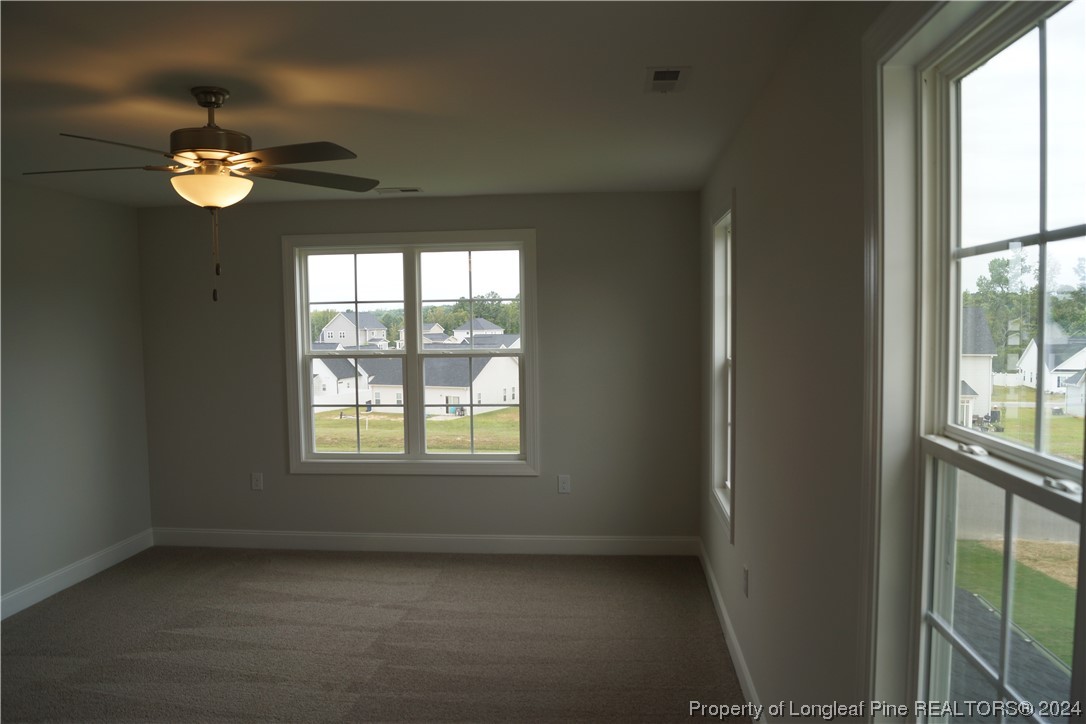 103 Grinnel Loop Sanford, NC 27332 - Photo 23 of 39 an empty room with windows and ceiling fan