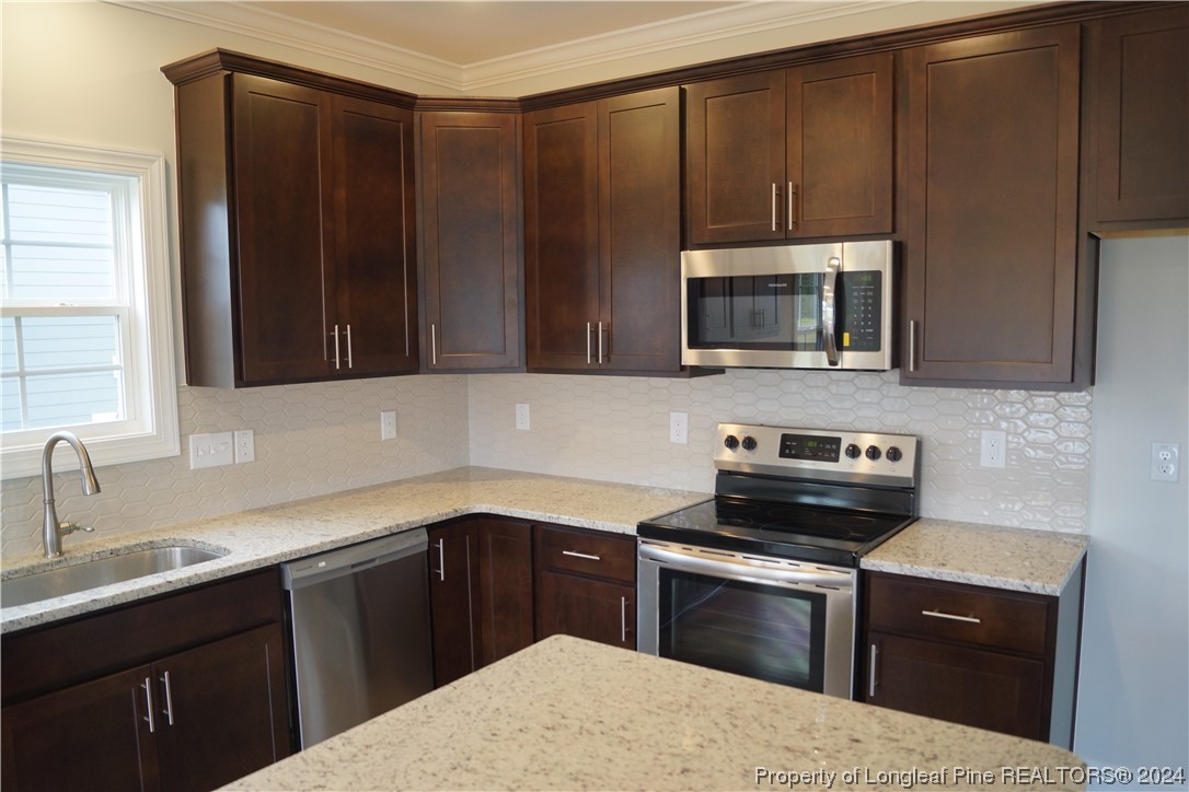 103 Grinnel Loop Sanford, NC 27332 - Photo 7 of 39 a kitchen with a sink stove and microwave