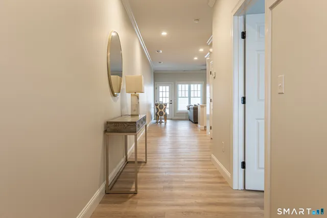 wooden floor in a hall with a bathroom