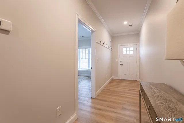 a view of hallway with wooden floor