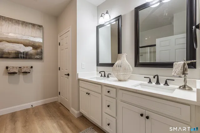 a bathroom with a double vanity sink and mirror