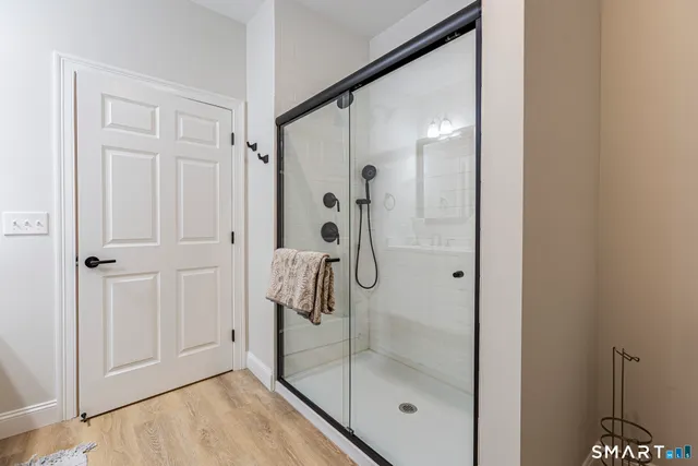 a bathroom with a glass shower door