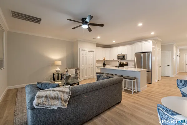 a living room with furniture kitchen and a table