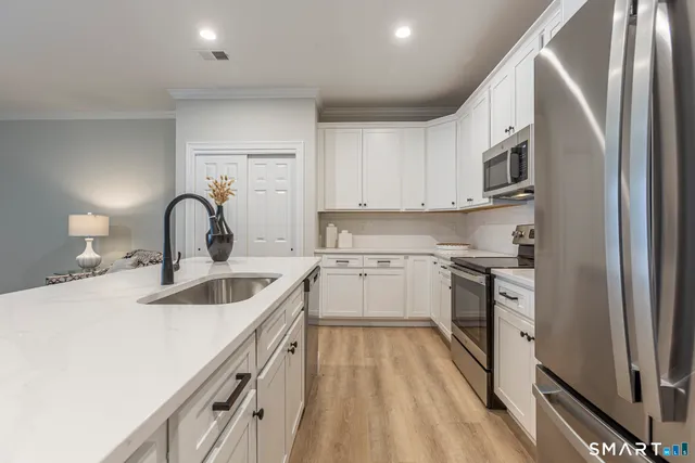 a kitchen with a sink cabinets and stainless steel appliances