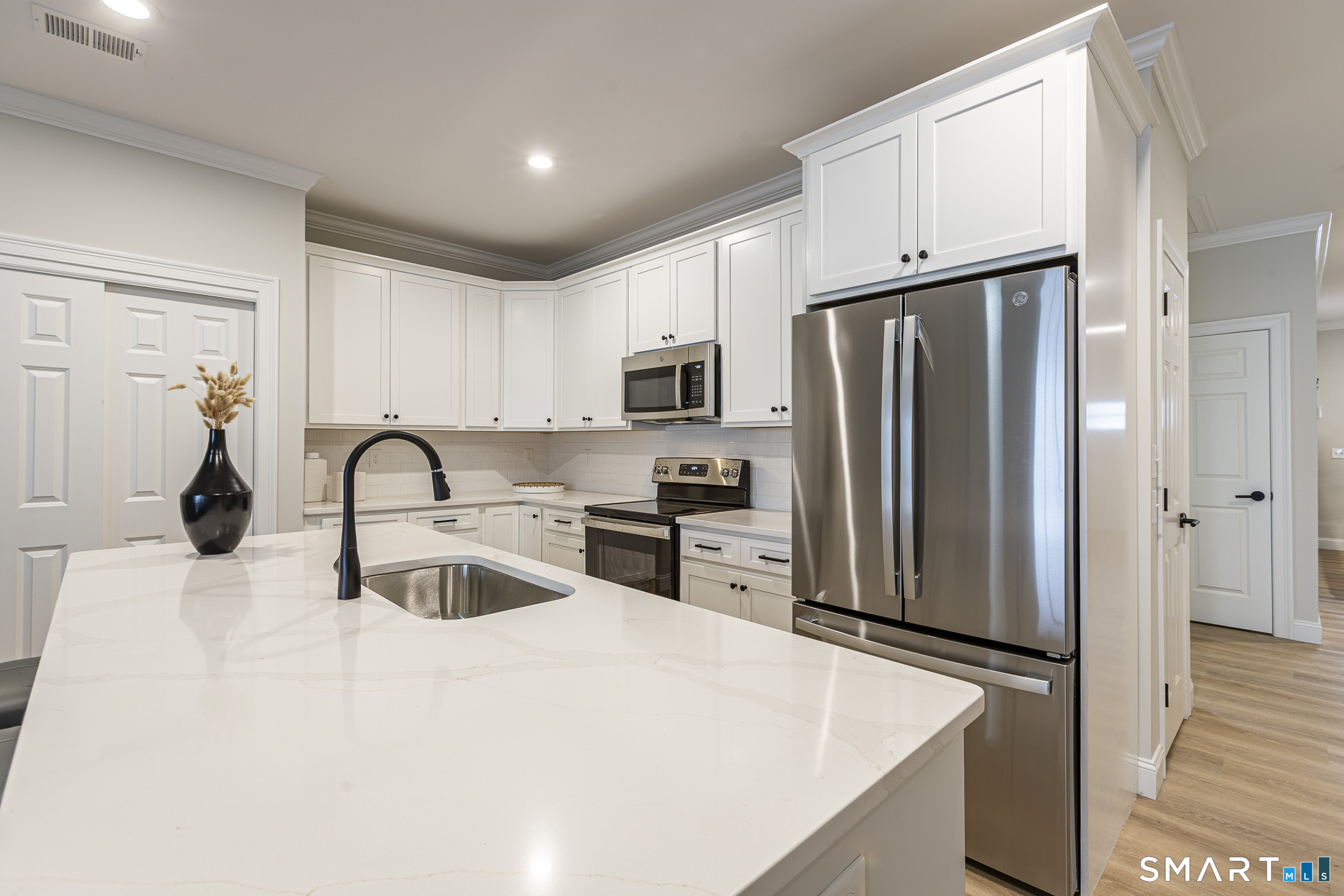 7 Loomis Road, Unit C Bolton, CT 06043 - Photo 5 of 26 a kitchen with stainless steel appliances a refrigerator stove microwave and sink