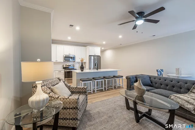 a living room with furniture and kitchen view