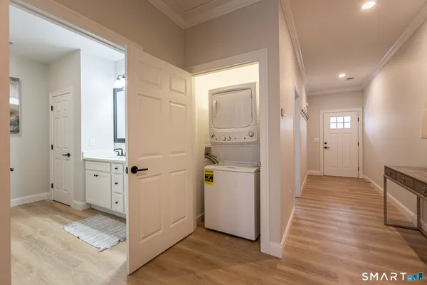 a view of a hallway with wooden floor